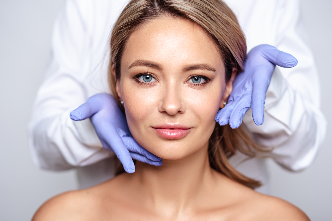 A woman with a flawless complexion receiving a professional consultation for Dysport treatment.